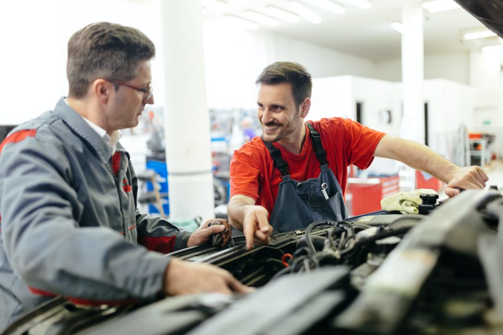 Car mechanics fixing car
